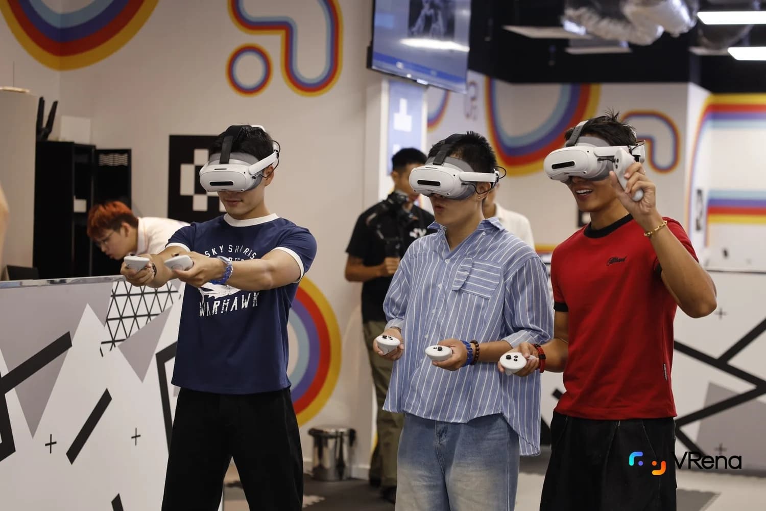 Friends wearing VR headsets in the VRena arena