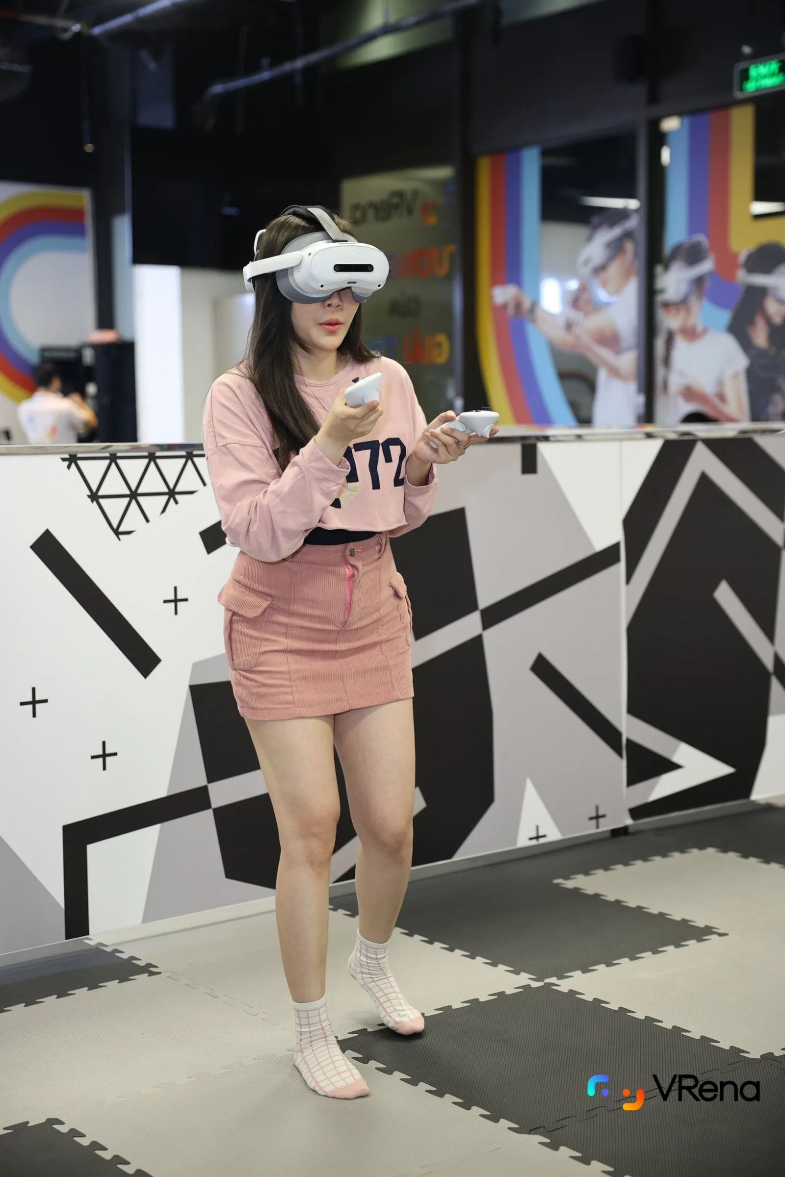 A guest in pink moving through a VR mission